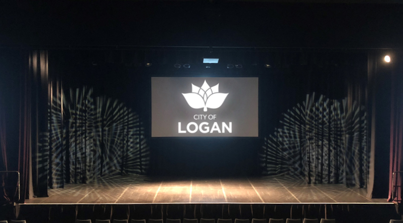 Logan City Council logo projected onto big screen at the back of a large stage