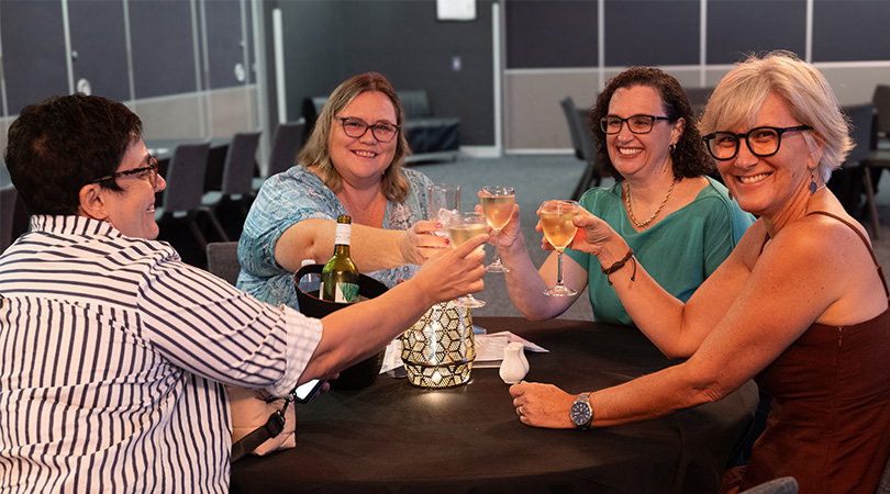 Four ladies celebrating with a white wine