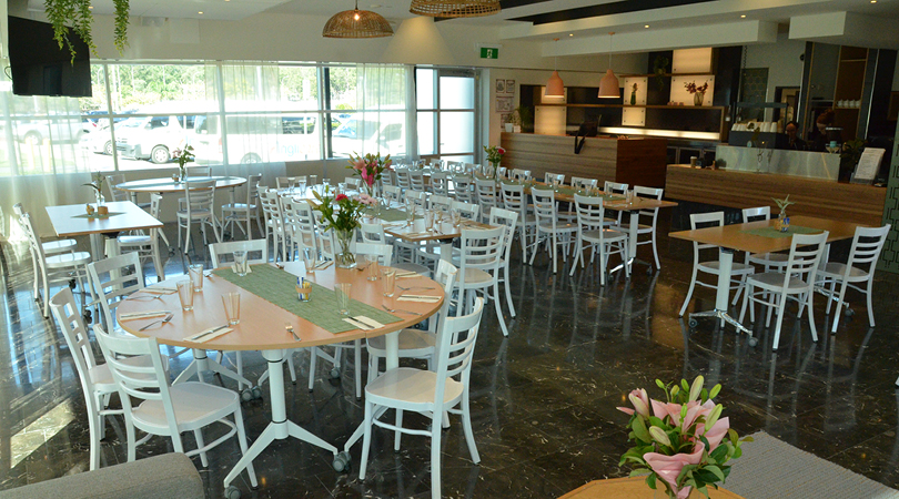 Interior of Limelight Bistro with cafe-style seating and fresh flowers on the tables