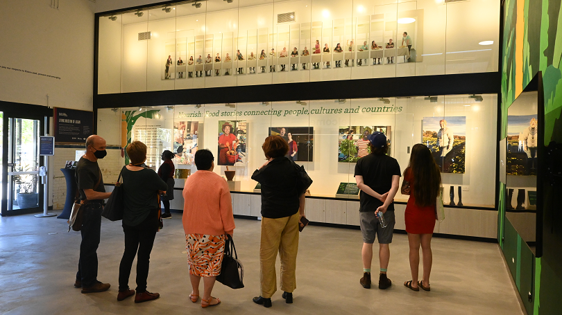 A group gathers around the Nourish display.