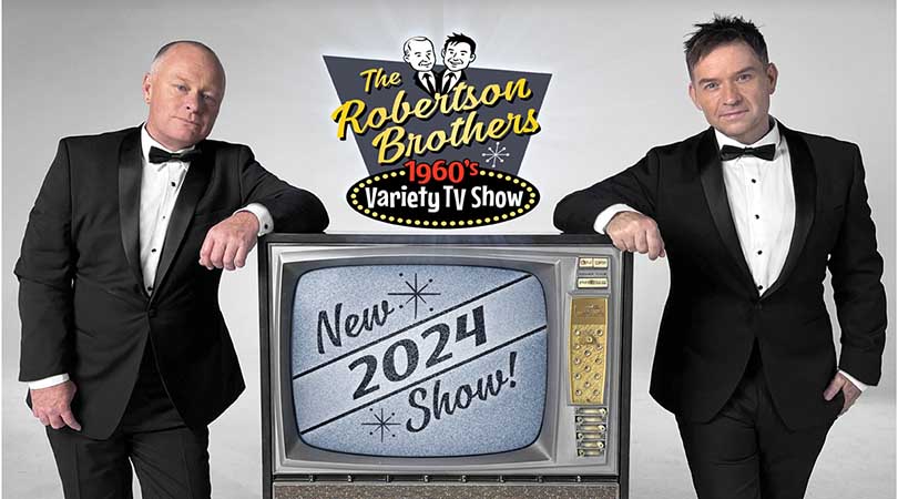 two men in black tuxedos leaning on an old style TV with The Robertson Brothers 1960's Variety TV Show logo