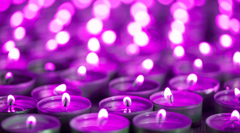 many tea light candles with purple tone